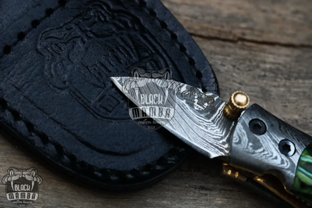BMK-415-GR Green Tsetse Fly 3.5″ Long 1.5″Blade” 2oz Damascus Neck Knives Handmade Damascus Pocket Folding Knife With Mammoth Tooth Handle Black Mamba Hand Made World Class Knives USA Made - Image 4