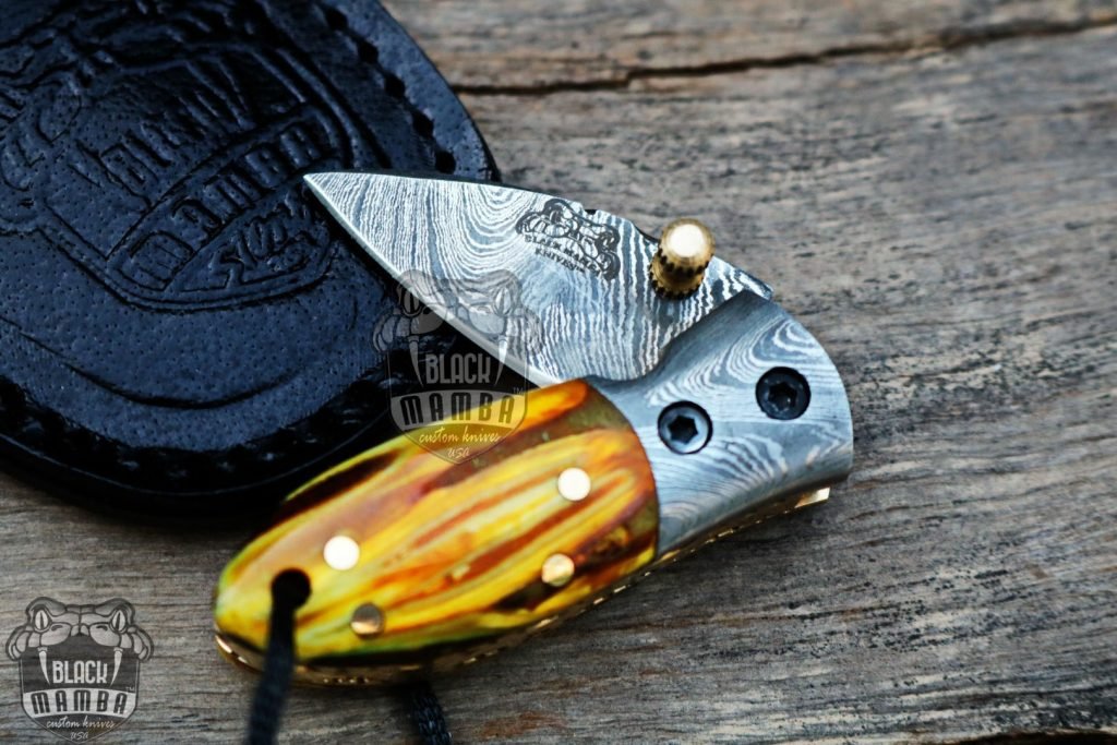 BMK-415YL Yellow Tsetse Fly 3.5″ Long 1.5″Blade” 2oz Damascus Neck Knives Handmade Damascus Pocket Folding Knife With Mammoth Tooth Handle Black Mamba Hand Made World Class Knives USA Made - Image 2