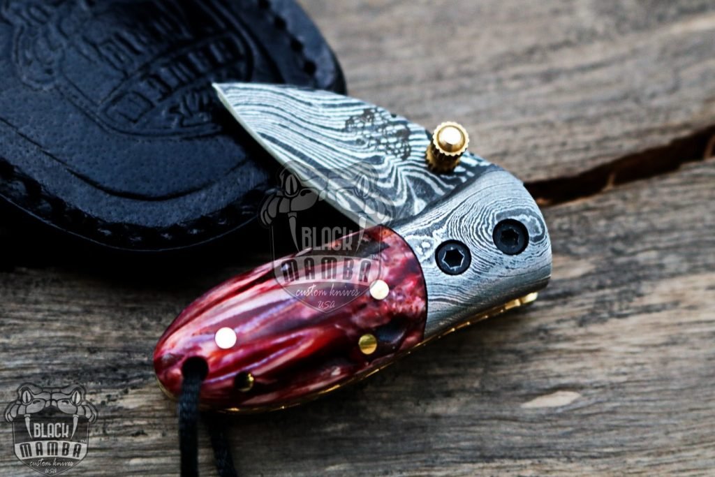 BMK-415-RD Red Tsetse Fly 3.5″ Long 1.5″Blade” 2oz Damascus Neck Knives Handmade Damascus Pocket Folding Knife With Mammoth Tooth Handle Black Mamba Hand Made World Class Knives USA Made - Image 2