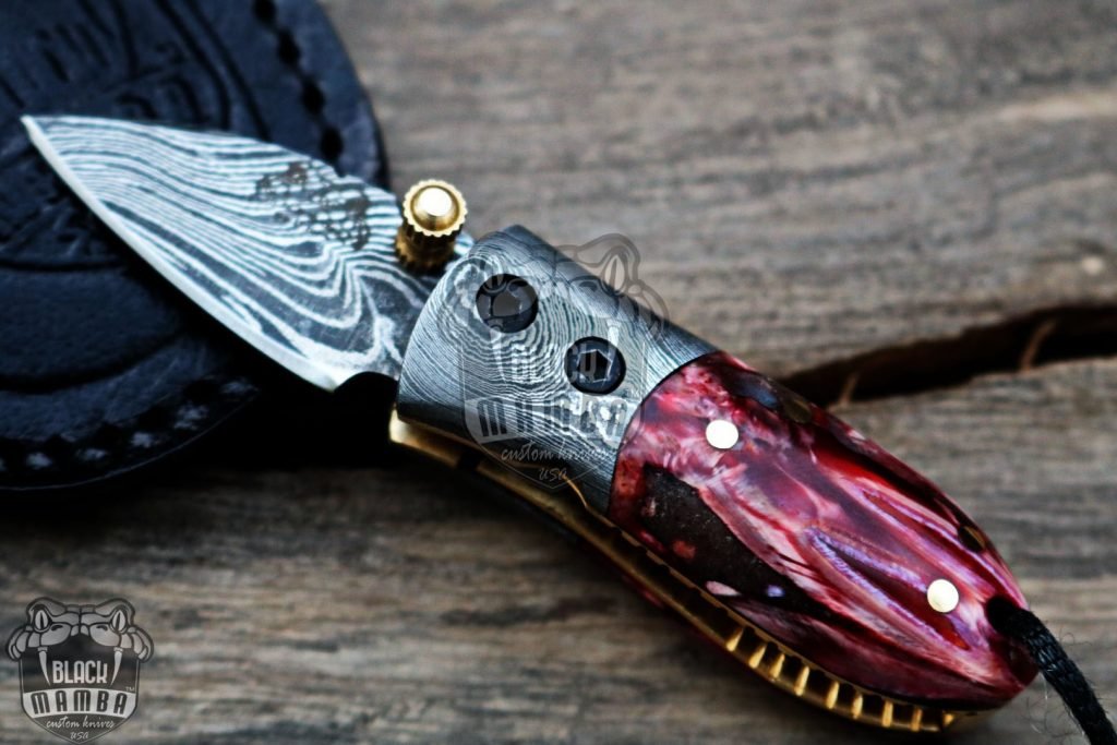 BMK-415-RD Red Tsetse Fly 3.5″ Long 1.5″Blade” 2oz Damascus Neck Knives Handmade Damascus Pocket Folding Knife With Mammoth Tooth Handle Black Mamba Hand Made World Class Knives USA Made - Image 3