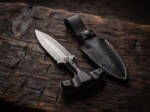 Ravenpoint Damascus push dagger with ebony wood T-handle and black leather sheath on dark wood