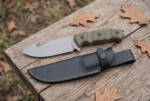 Moss Creek stonewashed D2 gut hook hunting knife with olive green Micarta handle and black leather sheath on a weathered board