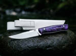 Violet Hour D2 straight back ladies knife with violet resin handle and white leather sheath on wet stone