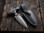 Ironfist Damascus push dagger with black Micarta T-handle, brass pins and black leather sheath