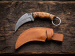 Sunfire Claw Damascus karambit knife with stabilised maple burl handle and tan leather sheath on dark wood