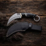 Onyx Fang Damascus karambit knife with buffalo horn handle, brass spacers, Damascus finger ring and black leather sheath