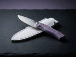 Lilac Trail D2 drop point ladies knife with lavender Micarta handle and white leather sheath on slate
