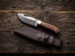 Grey Stalker satin D2 gut hook hunting knife with walnut handle, stainless bolster and oxblood leather sheath