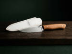 Golden Bough D2 drop point utility ladies knife with olive wood handle and white leather sheath on dark wood