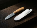 Meadowlark D2 spey point ladies knife with olive wood handle and white leather sheath on weathered wood