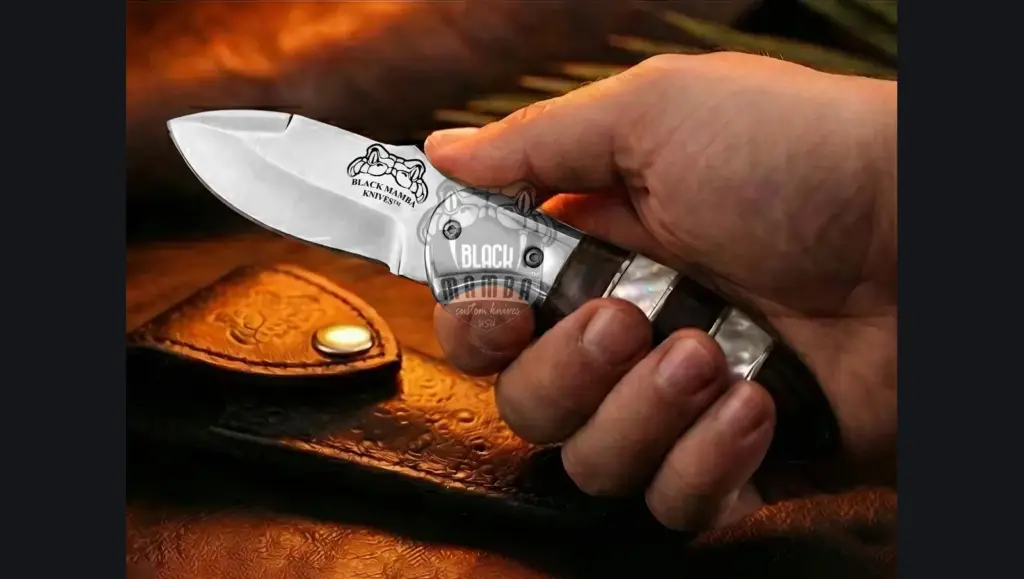 Six matching engraved Damascus folding knives laid out as groomsmen gifts