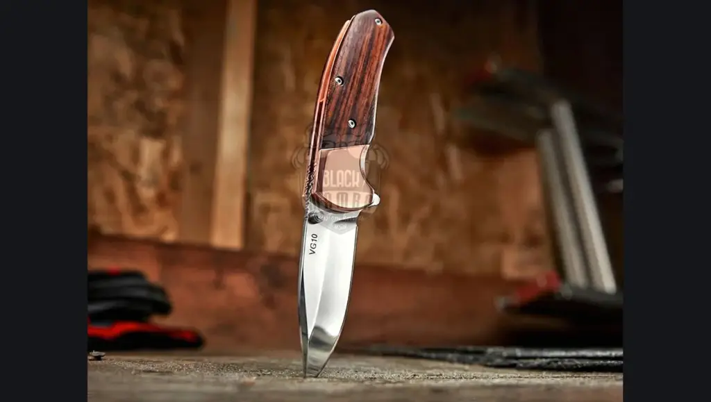 Engraving stylus cutting initials into the bolster of a Damascus knife