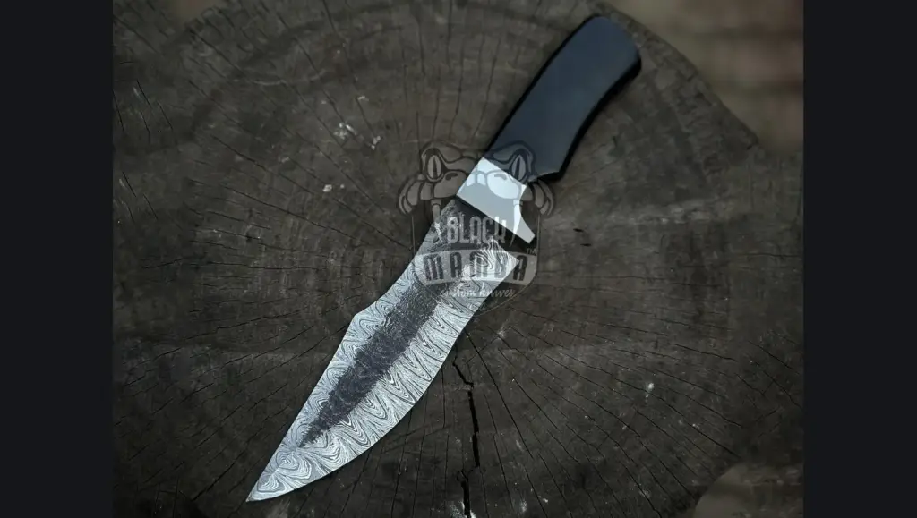 Damascus kukri field blade and utility knife on a canvas duffel with paracord