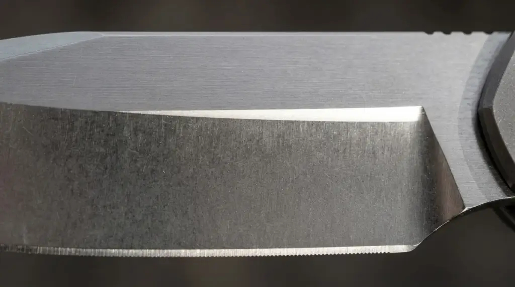Macro of a folder blade where the grind begins partway down from the spine