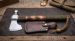 Scorch Ridge D2 steel camp tomahawk axe with mirror polished head, torched hickory haft, olive paracord wrap, braided wrist loop and brown leather belt sheath