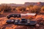 Obsidian Crest D2 steel Tom Brown style tracker knife with mirror polished blade and black micarta handle at desert sunset