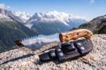 Summit Burl mirror polished D2 steel Tom Brown style tracker knife with olive burl wood handle and stainless pipe inlay in the mountains