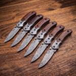 Set of 6 matching Fallen Damascus folding pocket knives with dark wood handles