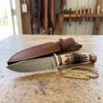 Bobcat Damascus hunting knife BMK-103 with stag antler and black horn handle with brown leather sheath